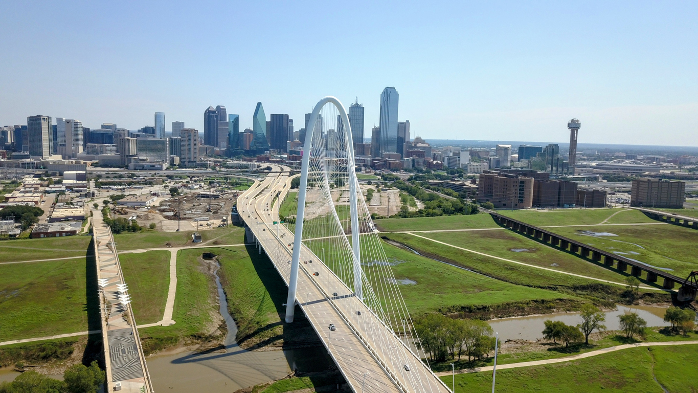 Aerial shot captured of the Margret Hunt Hill Bridge facing towards Downtown Dallas skyline